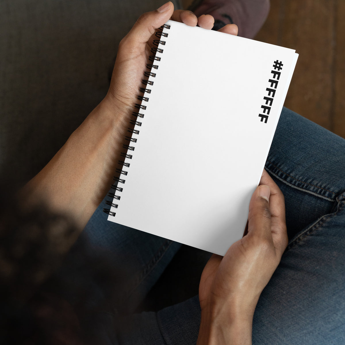 #FFFFFF Hex Code white spiral notebook held in two hands