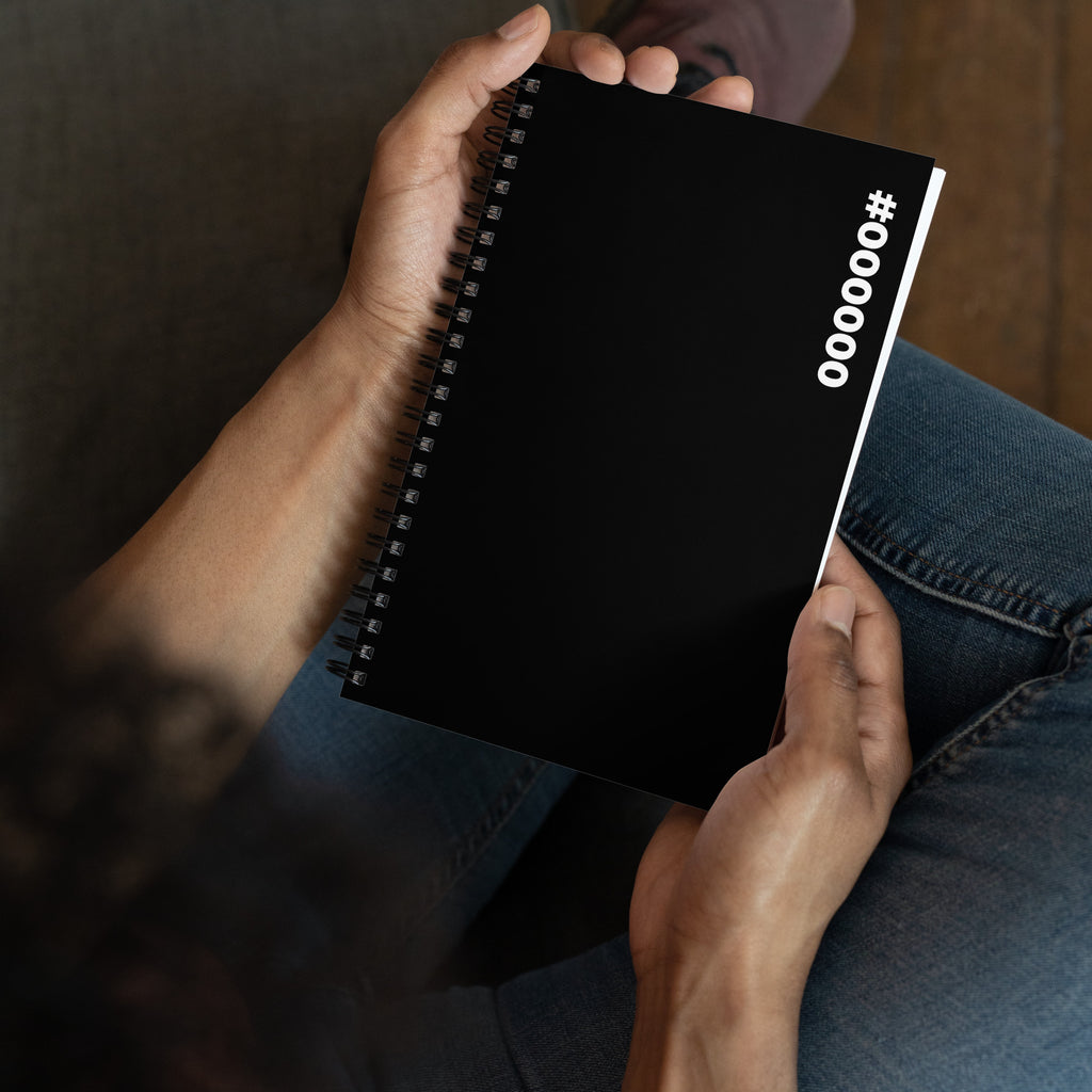 #000000 Hex Code black spiral notebook held in two hands